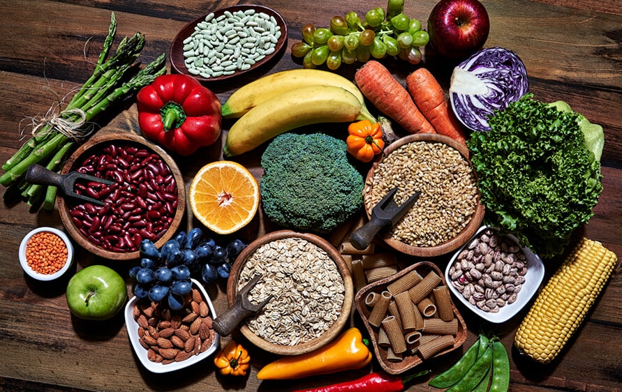 Photo collage of beans, grains, nuts, whole wheat pasta, fruits and vegeables